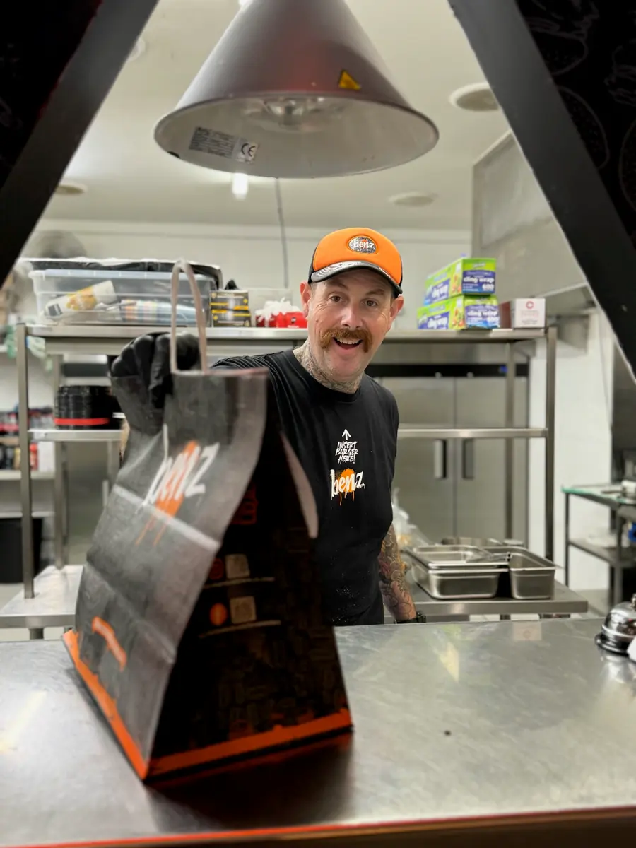 A Mr Jeebus order going out across the pass in the kitchen.